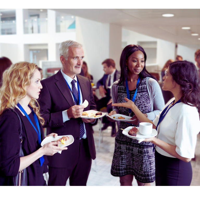 Group of practitioner attendees talking at an event